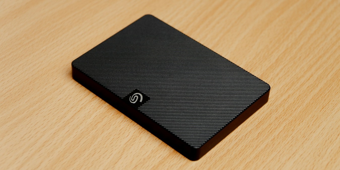 Black external hard drive on a brown desk