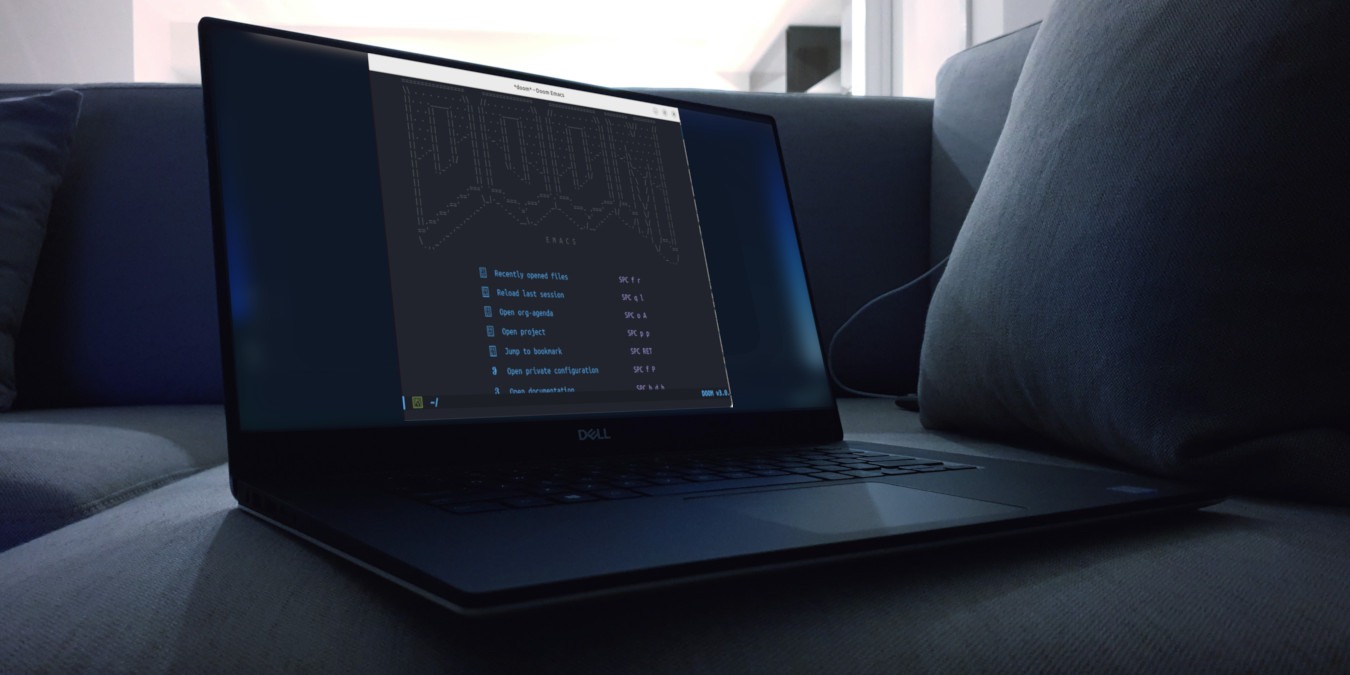 A photograph of a laptop on top of a couch.