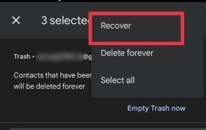 Selecting "Recover" option in Trash folder on Google Contacts app.